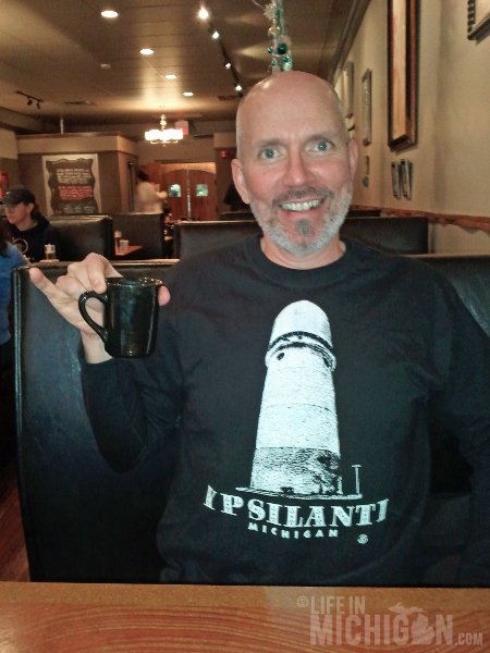 Chuck Marshall showing off his Ypsi t-shirt at the Poppycock restaurant 