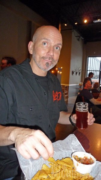 Slayer guy enjoys beer, chips and salsa