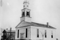 The Methodist church at Ann Arbor and Henry Streets, 1857-1899\"The Methodist Episcopal Church was built in 1837 on the corner of S. Ann Arbor and Henry Street. The house alongside to the north was the parsonage. Photo coutesy of the Saline Area Historical Society