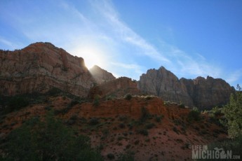 Sun peaking over mountain on Watchman Trail
