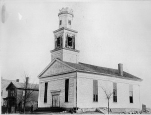 The Methodist church at Ann Arbor and Henry Streets, 1857-1899"The Methodist Episcopal Church was built in 1837 on the corner of S. Ann Arbor and Henry Street. The house alongside to the north was the parsonage. Photo coutesy of the Saline Area Historical Society