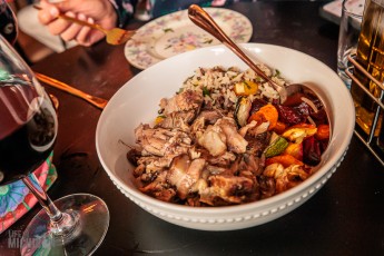 Strega Nonna - a red wine-braised pork shoulder infused with poultry herbs, raisins, citrus and served over a bed of wild rice with local root vegetables.
